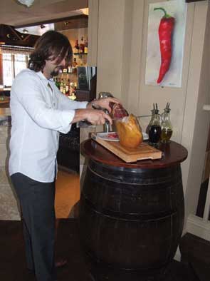 Sergio carves wafer-thin slices of Jamon Serrano ham, a Spanish national delicacy.